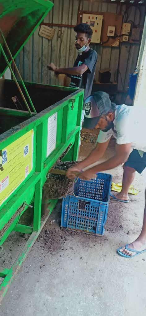 Worker loading processed material into a crate