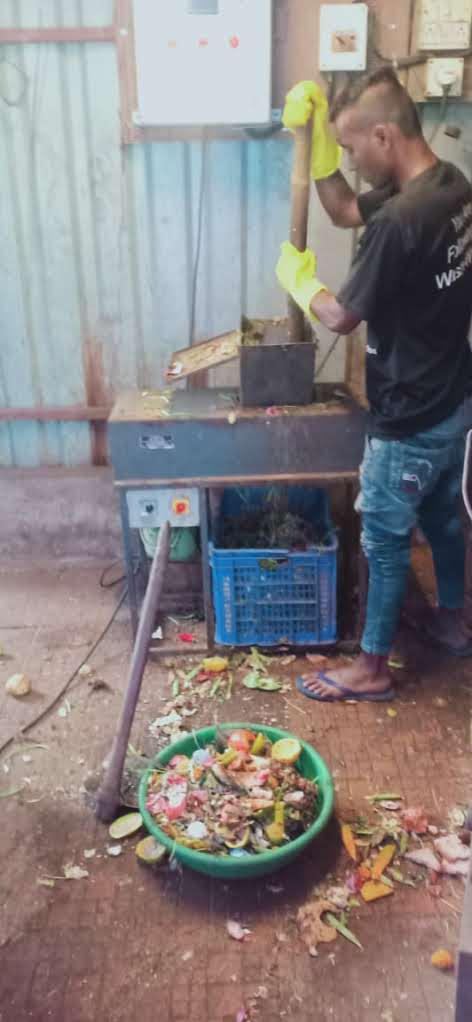 Worker operating a shredding machine with safety gloves